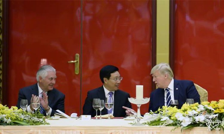 U.S. Secretary of State Rex Tillerson, Vietnamese Deputy Prime Minister and Minister of Foreign Affairs Pham Binh Minh and President Donald J. Trump talk during a State Dinner in Hanoi on November 11, 2017.