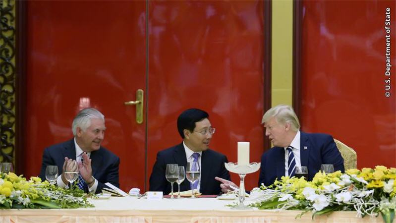 U.S. Secretary of State Rex Tillerson, Vietnamese Deputy Prime Minister and Minister of Foreign Affairs Pham Binh Minh and President Donald J. Trump talk during a State Dinner in Hanoi on November 11, 2017.